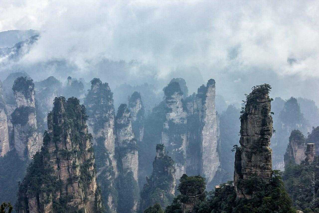 Одинокая скала в каньоне облачных джунглей